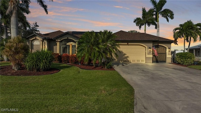 24342 Saragossa Ln, Punta Gorda, FL 33955 - view of front of house featuring a front yard, stucco siding, a garage, and concrete driveway