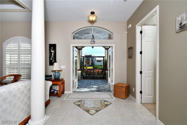 24342 Saragossa Ln, Punta Gorda, FL 33955 - tiled entryway featuring baseboards and ornate columns