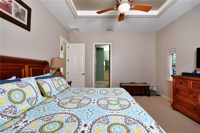 24342 Saragossa Ln, Punta Gorda, FL 33955 - carpeted bedroom with ensuite bath, ceiling fan, visible vents, and a raised ceiling