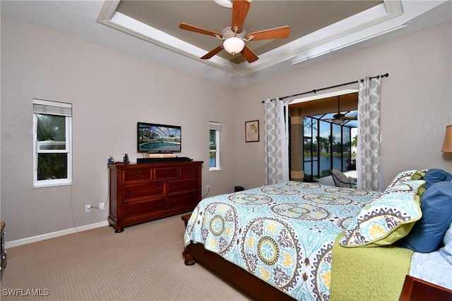 24342 Saragossa Ln, Punta Gorda, FL 33955 - bedroom featuring baseboards, carpet floors, access to exterior, and a raised ceiling