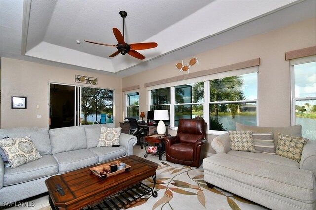 24342 Saragossa Ln, Punta Gorda, FL 33955 - living room with a tray ceiling and ceiling fan