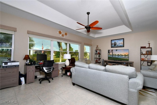 24342 Saragossa Ln, Punta Gorda, FL 33955 - living area featuring light tile patterned floors, a tray ceiling, and ceiling fan