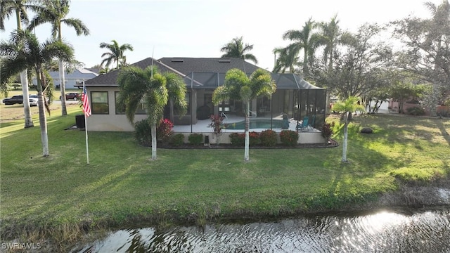 24342 Saragossa Ln, Punta Gorda, FL 33955 - exterior space featuring an outdoor pool, stucco siding, a lanai, a water view, and a lawn