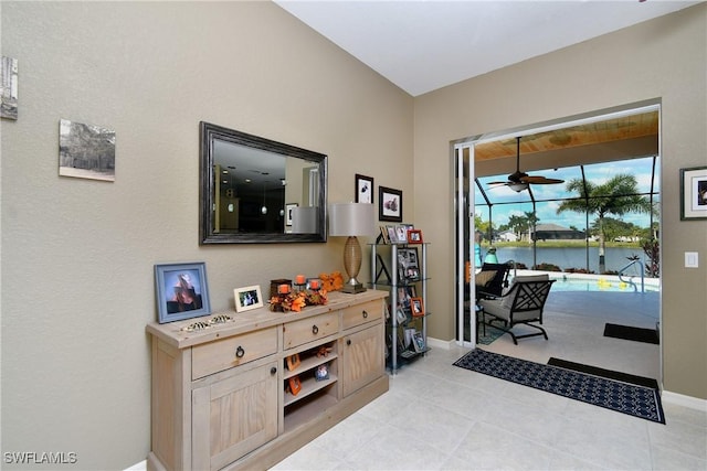 24342 Saragossa Ln, Punta Gorda, FL 33955 - interior space with a ceiling fan, light tile patterned flooring, a water view, and baseboards