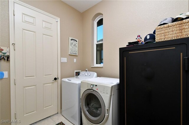 24342 Saragossa Ln, Punta Gorda, FL 33955 - laundry room with light tile patterned flooring, washing machine and clothes dryer, and laundry area