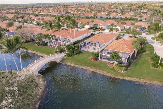 bird's eye view with a water view and a residential view