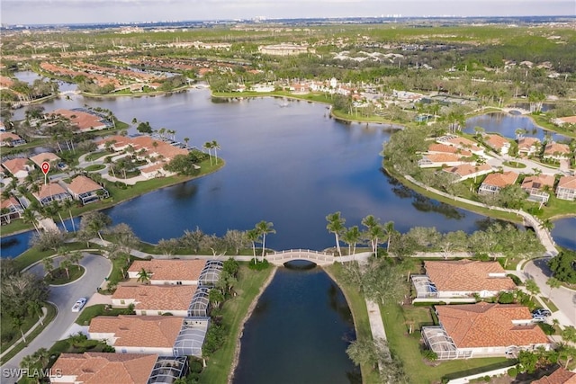 drone / aerial view with a water view and a residential view