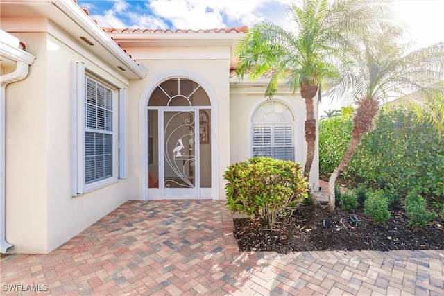 property entrance with stucco siding