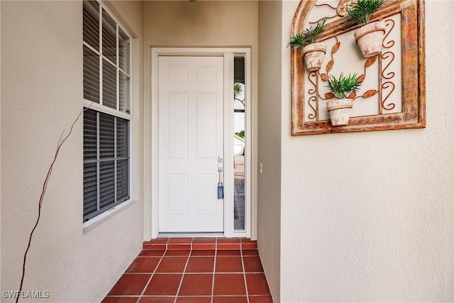view of exterior entry featuring stucco siding