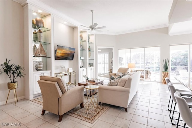living room featuring a ceiling fan, ornamental molding, built in shelves, and light tile patterned floors