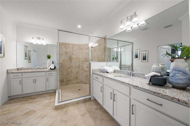 14600 Sycamore Ct Unit 2022, Punta Gorda, FL 33955 - full bath with crown molding, a shower stall, two vanities, and tile patterned flooring