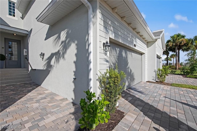 14600 Sycamore Ct Unit 2022, Punta Gorda, FL 33955 - view of side of home with stucco siding, entry steps, and a garage