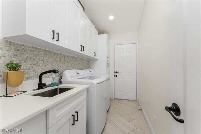 12484 SW Sheri Ave, Lake Suzy, FL 34269 - laundry room with cabinet space, washing machine and dryer, baseboards, and recessed lighting