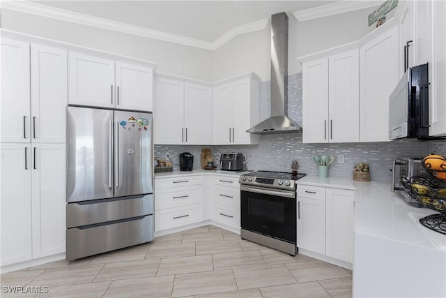 kitchen with wall chimney range hood, backsplash, light countertops, and appliances with stainless steel finishes
