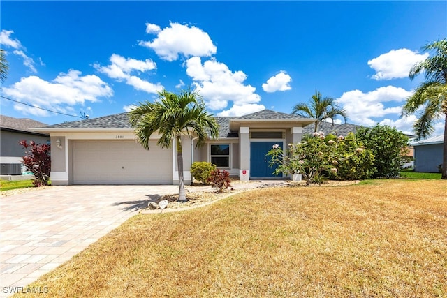 3801 SW 1st Ln, Cape Coral, FL 33991 - single story home with decorative driveway, a garage, a front yard, and stucco siding
