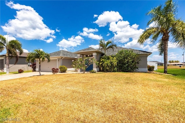 3801 SW 1st Ln, Cape Coral, FL 33991 - view of front of house featuring concrete driveway, an attached garage, a front yard, and stucco siding