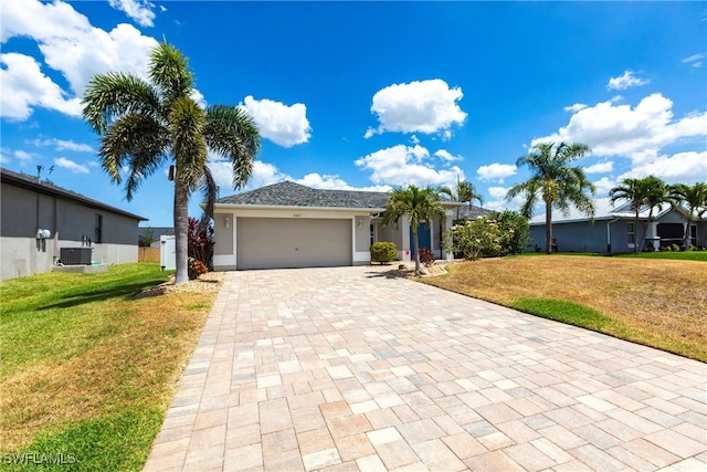 3801 SW 1st Ln, Cape Coral, FL 33991 - ranch-style house featuring an attached garage, decorative driveway, a front lawn, and cooling unit