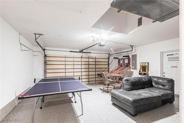 3801 SW 1st Ln, Cape Coral, FL 33991 - recreation room with a garage, a wall mounted AC, speckled floor, and electric panel