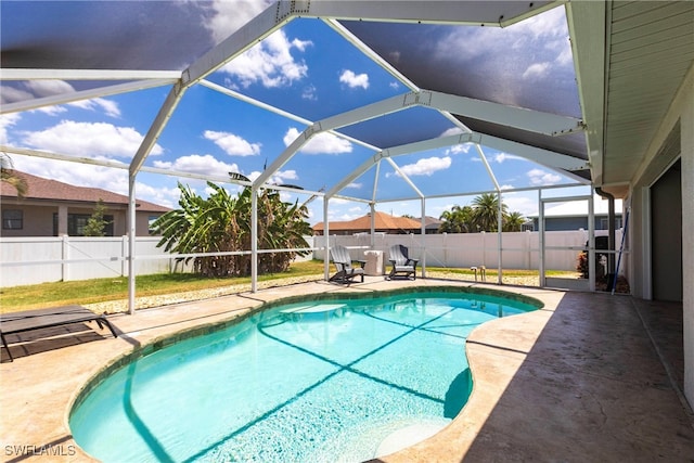 3801 SW 1st Ln, Cape Coral, FL 33991 - view of swimming pool featuring glass enclosure, a patio, a fenced in pool, and a fenced backyard