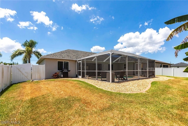 3801 SW 1st Ln, Cape Coral, FL 33991 - rear view of house with stucco siding, a fenced backyard, a gate, a patio area, and a lawn