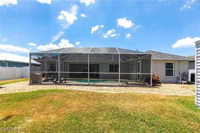 3801 SW 1st Ln, Cape Coral, FL 33991 - rear view of property with a lanai, a lawn, an outdoor pool, fence, and stucco siding