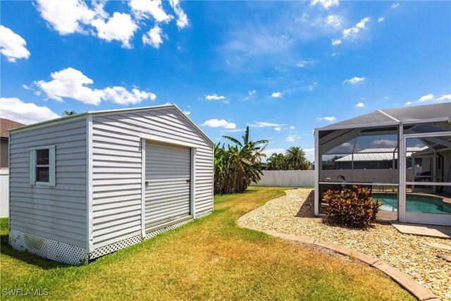 3801 SW 1st Ln, Cape Coral, FL 33991 - view of yard with a storage unit, a fenced backyard, a fenced in pool, a lanai, and an outdoor structure