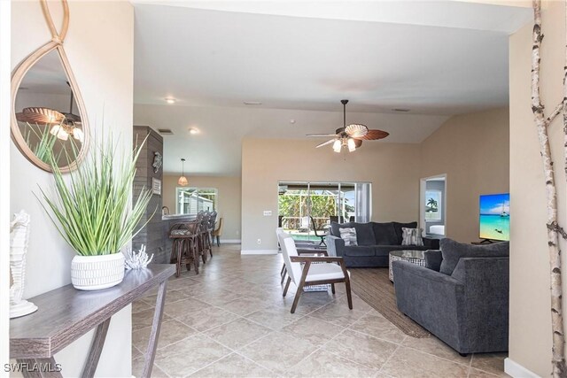 3801 SW 1st Ln, Cape Coral, FL 33991 - living area with a ceiling fan, baseboards, light tile patterned floors, and lofted ceiling