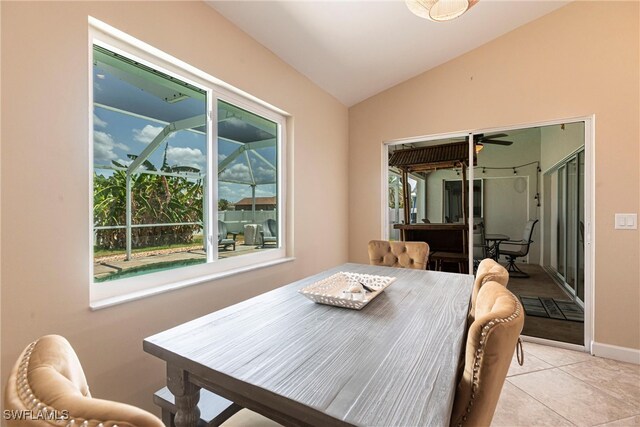 3801 SW 1st Ln, Cape Coral, FL 33991 - dining room featuring baseboards, ceiling fan, light tile patterned floors, and vaulted ceiling