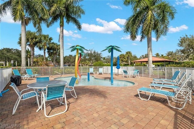 14768 Cranberry Ct, Naples, FL 34114 - exterior space featuring a patio area, a community pool, and fence