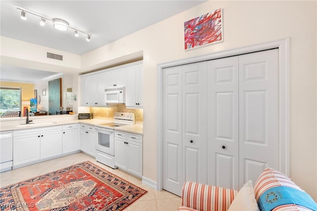10520 Amiata Way Unit 104, Fort Myers, FL 33913 - kitchen featuring white appliances, light tile patterned flooring, white cabinetry, and light countertops