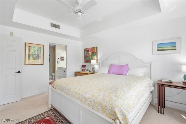 10520 Amiata Way Unit 104, Fort Myers, FL 33913 - bedroom featuring light colored carpet, a raised ceiling, connected bathroom, and ceiling fan