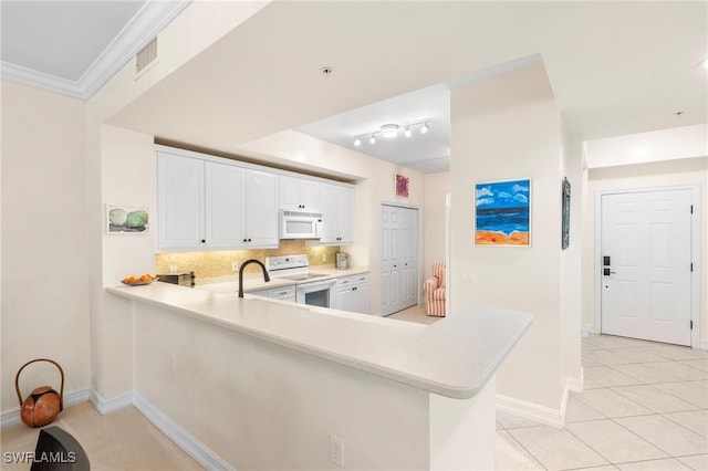 10520 Amiata Way Unit 104, Fort Myers, FL 33913 - kitchen with white appliances, light countertops, tasteful backsplash, white cabinetry, and a peninsula