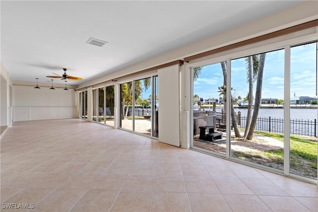 2020 Aruba Ave, Fort Myers, FL 33905 - unfurnished room featuring a water view, light tile patterned flooring, and a ceiling fan