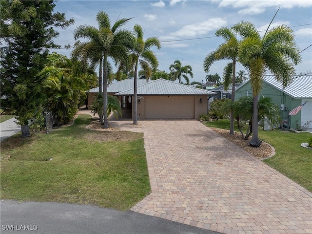 2020 Aruba Ave, Fort Myers, FL 33905 - single story home featuring decorative driveway, an attached garage, a front yard, and metal roof