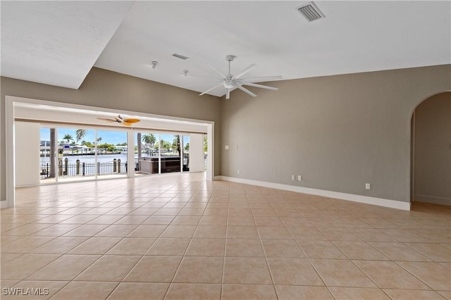 2020 Aruba Ave, Fort Myers, FL 33905 - unfurnished room featuring ceiling fan, arched walkways, light tile patterned floors, a water view, and baseboards
