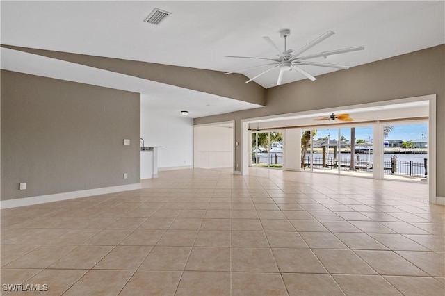 2020 Aruba Ave, Fort Myers, FL 33905 - empty room featuring ceiling fan, baseboards, light tile patterned flooring, lofted ceiling, and a water view
