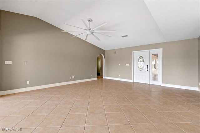 2020 Aruba Ave, Fort Myers, FL 33905 - unfurnished living room featuring vaulted ceiling, a ceiling fan, arched walkways, light tile patterned flooring, and baseboards
