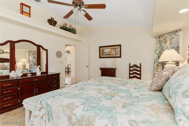 bedroom featuring vaulted ceiling, arched walkways, ceiling fan, and light tile patterned floors
