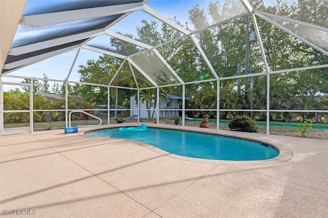 pool with a storage unit, an outdoor structure, a lanai, and a patio area