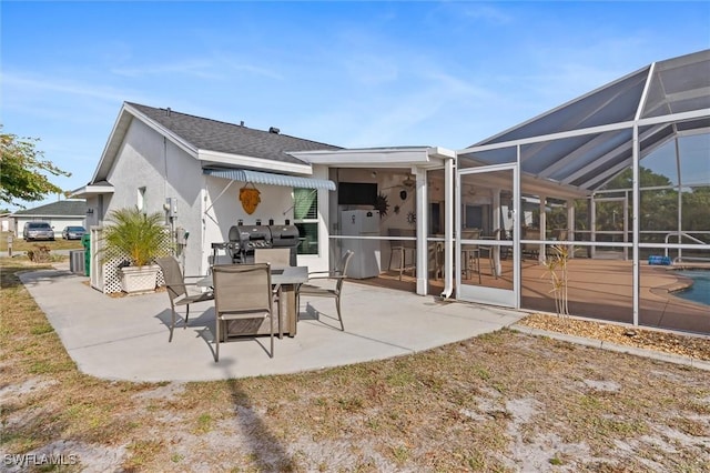 view of patio with area for grilling, an outdoor pool, outdoor dining area, and a lanai