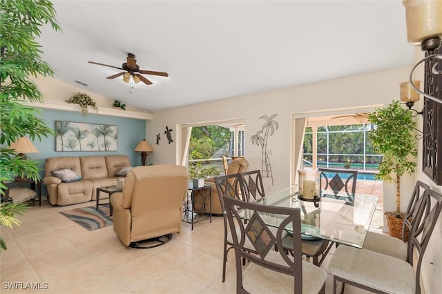 interior space featuring light tile patterned flooring, lofted ceiling, visible vents, and ceiling fan