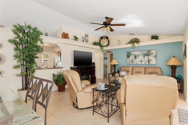 living room with a ceiling fan, light tile patterned flooring, lofted ceiling, and visible vents