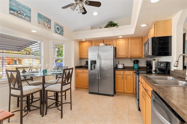 kitchen featuring recessed lighting, a sink, dark countertops, ceiling fan, and appliances with stainless steel finishes