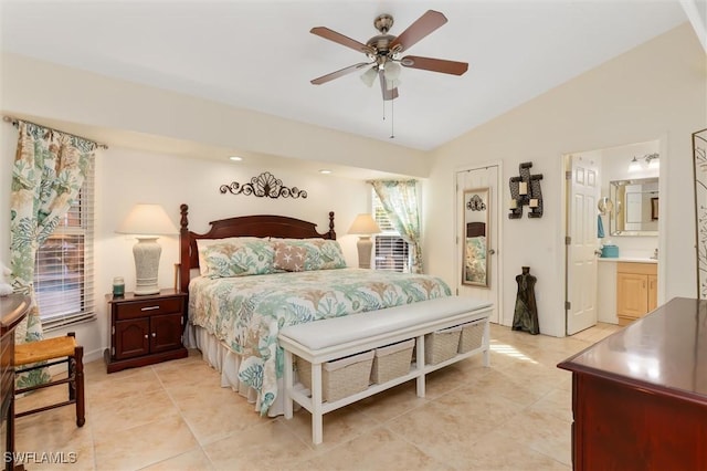 bedroom with connected bathroom, lofted ceiling, ceiling fan, and light tile patterned floors