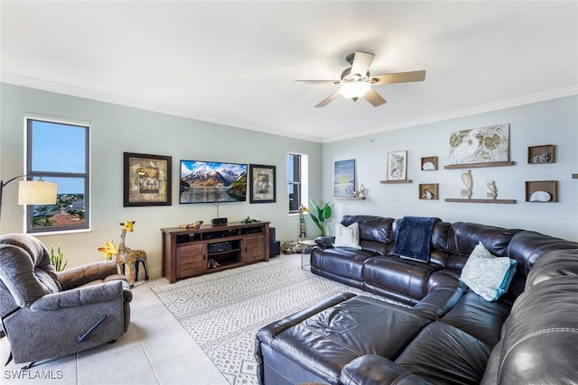 living room with light tile patterned flooring, ceiling fan, ornamental molding, and a healthy amount of sunlight