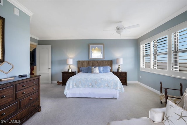 carpeted bedroom featuring a ceiling fan, ornamental molding, and baseboards