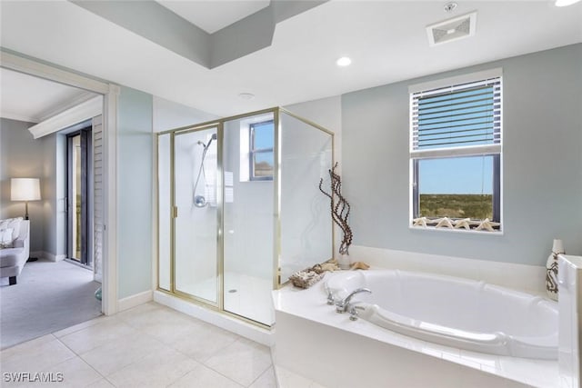 bathroom featuring a bath, visible vents, tile patterned floors, and a stall shower