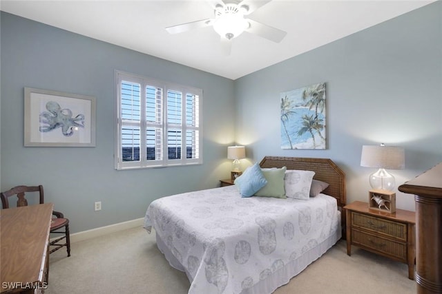 bedroom with a ceiling fan, carpet floors, and baseboards