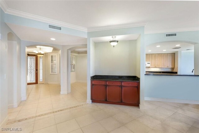 11600 Court Of Palms Unit 506, Fort Myers, FL 33908 - unfurnished living room featuring arched walkways, a chandelier, light tile patterned flooring, crown molding, and baseboards