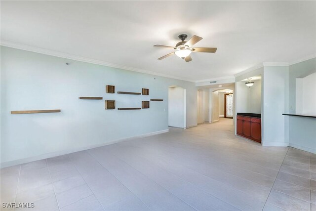 11600 Court Of Palms Unit 506, Fort Myers, FL 33908 - empty room featuring arched walkways, a ceiling fan, ornamental molding, light tile patterned floors, and baseboards